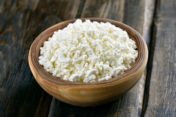 Curd in bowl on wooden table