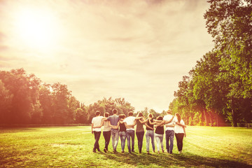 Group of Teenage Friends in the Park at Sunset - obrazy, fototapety, plakaty
