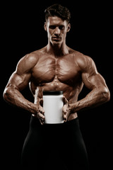 muscular man holding jar with protein