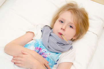 Sick little girl lying in the bed with temperature