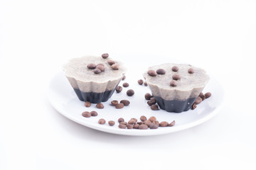 Handmade soap in the shape of muffins with coffee beans on a white plate