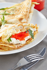 pancakes stuffed with a red caviar