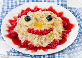 Smiling oatmeal and fresh berries for breakfast.
