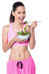 Pretty fit woman having salad