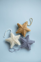 Fototapeta na wymiar Knitted stars for Christmas tree 