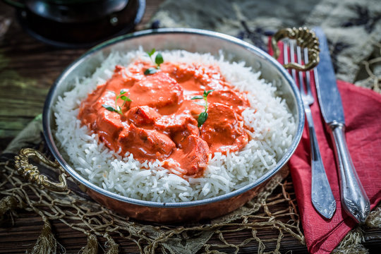 Delicious tikka masala with rice and tomato sauce