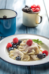 Delicious dumplings with berry fruits and cream