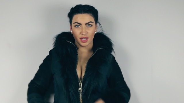 Beautiful brunette unbuttoned sheepskin coat