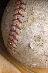 Fototapeta na wymiar well-used softball in mitt