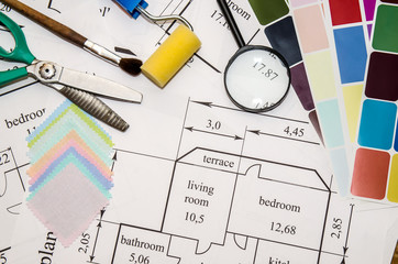 architectural plan of the house, color palette, furniture and fabric samples on wooden table