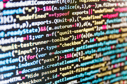 Software developer programming code on computer. Abstract computer script source code. Shallow depth of field, selective focus effect. 