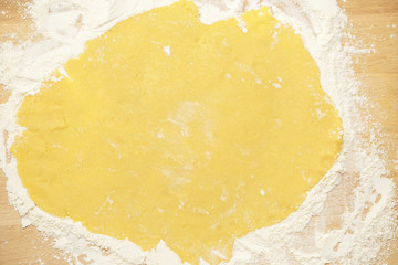Homemade pie preparation recipe. Dough on wooden board.