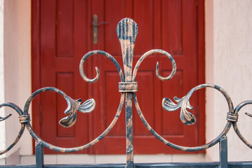 close up element of iron fence, curves and curls. background