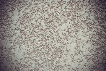 Decorative plaster wall with yellow structure as texture