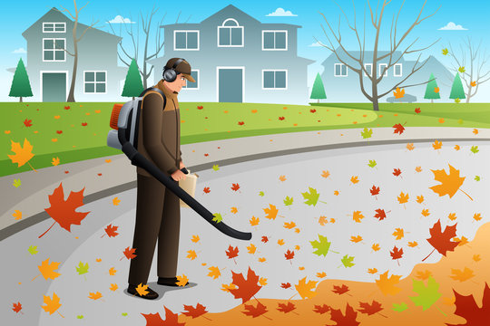 Man Clean Up Leaves During Fall Season Using a Blower