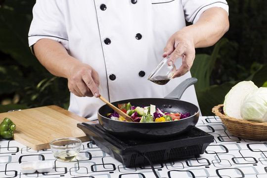 Chef cooking stir fried vegetable