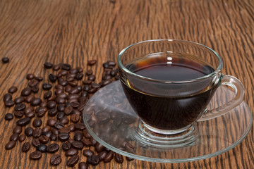 Coffee cup and coffee beans on table