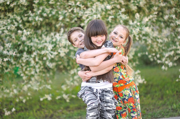 Fototapeta na wymiar three children playing on meadow in summer