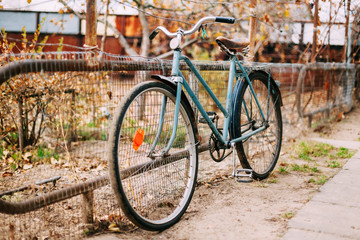 Fototapeta na wymiar Parked vintage old bicycle bike in courtyard.