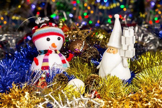 Christmas decoration, Snowman, Santa, balls, tinsel on blurred lights background