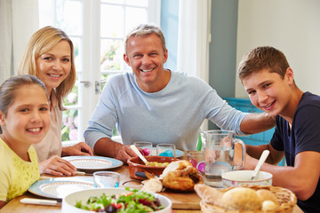Obraz na płótnie Canvas Portrait Of Family Enjoying Meal At Home Together