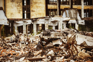 A closeup image of a garbage dump at ruined building background