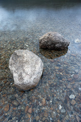 Closeup of boulders in shallow water.