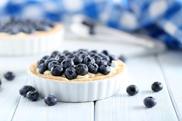 Blueberry tart on blue wooden table