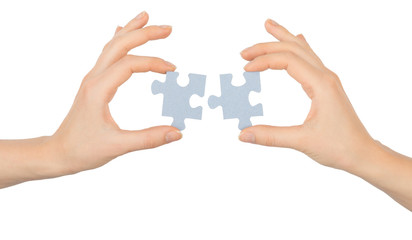 Hands holding puzzle pieces