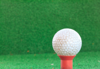 selective focus golf ball,tee on the blur grass  background.