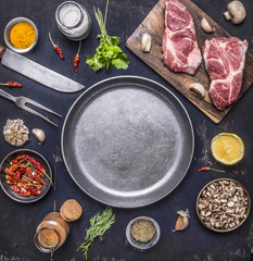 raw pork steak with herbs, mushrooms and garlic around the pan place for text,frame on wooden rustic background top view