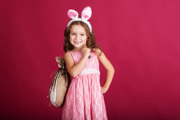 Child girl with pink is wearing bunny ears 