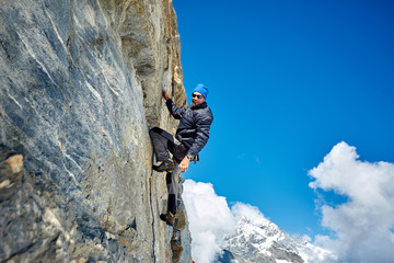climber climbing up a cliff