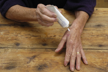 Older woman with cream on her hands