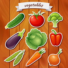 Fresh vegetables on wooden background. Cucumber, tomato, broccoli, eggplant, cabbage, peppers, peas, carrots, onions