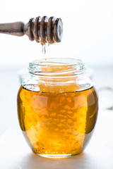 Dripping honey into jar