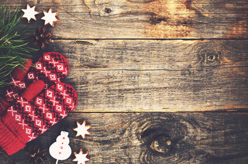Red knitted mittens on wooden background