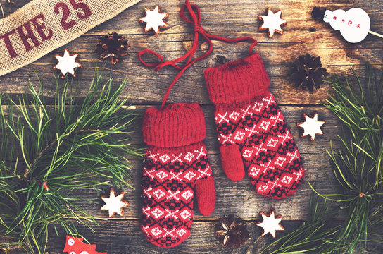 Winter decoration with red knitted mittens and christmas toys