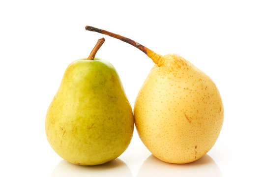 Green and yellow pears on white