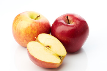 Fototapeta na wymiar Two apples and half isolated on white