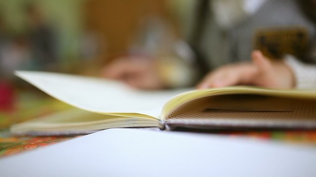 girl teen read book schoolgirl big hands sitting at desk in classroom school