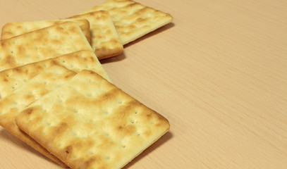 Selective focus cracker on wooden background.