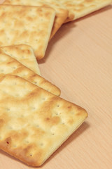Selective focus cracker on wooden background.
