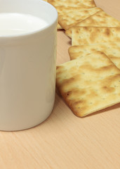 Selective focus craker  and milk  on wood background.