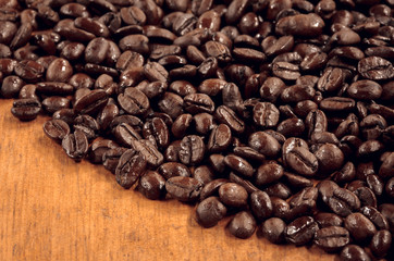 selective focus coffee bean  on wood background.