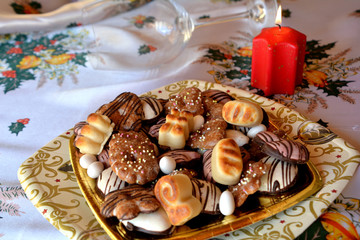 Christmas decorated gingerbread cookies on the table with lighted candle