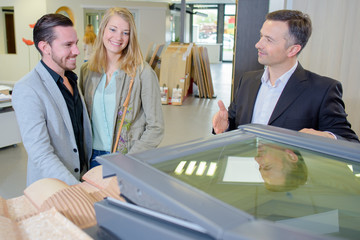 Salesman showing couple an opening roof light