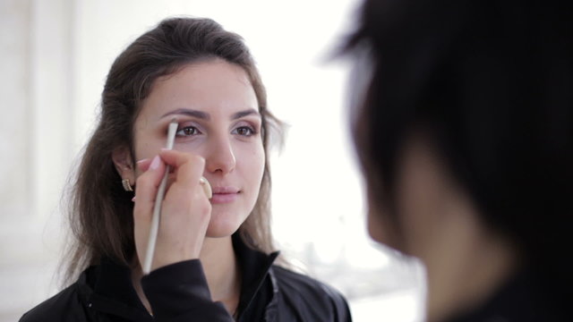 Visage master doing make-up for young model close-up picture