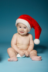 boy in diapers with hat of Santa Claus