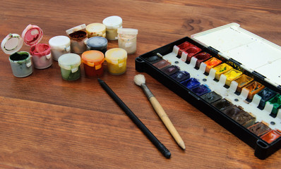 Table of the artist with paints, brushes, pencils